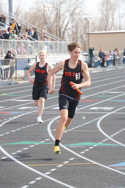 Red Oak’s Hayden Hietbrink, shown here on the anchor leg of the sprint medley relay, won the 800-meters and finished second in the 1,600 at the Council Bluffs Lewis Central 9-10 Relays. (Joel Stevens/ The Red Oak Express)
