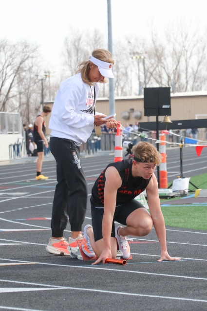 Hudson Fisher gets some starting block assistant from Red Oak head coach Sueann French before the sprint medley relay. The Tigers went on to finish seventh in the event. (Joel Stevens/ The Red Oak Express)