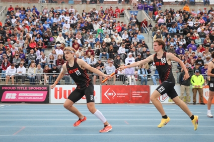 Red Oak’s Reese Montgomery takes the baton handoff from Bryce Williams in the 4x800-meter relay at the state track meet Friday. The Tigers would go on to place ninth in the event in a time of 8:13.16. (Joel Stevens/ The Red Oak Express)