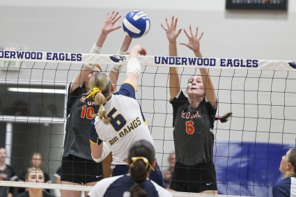 Red Oak’s Kenzie Wilcoxson and Natalie Johnson rise up to block an Underwood hitter in the Western Iowa Conference Tournament championship. (Renander Photos)