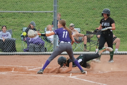 East Mills’ Reagan Thornburg slides into home to just beat the tag of Stanton’s Quinn McDonald in the Viking’s Corner Conference Softball Tournament win Thursday. (Joel Stevens/ The Red Oak Express)